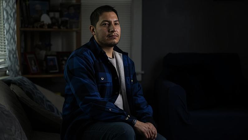 A Dreamer, whose renewal was so delayed that he lost his job, sits in his home on 4 March.