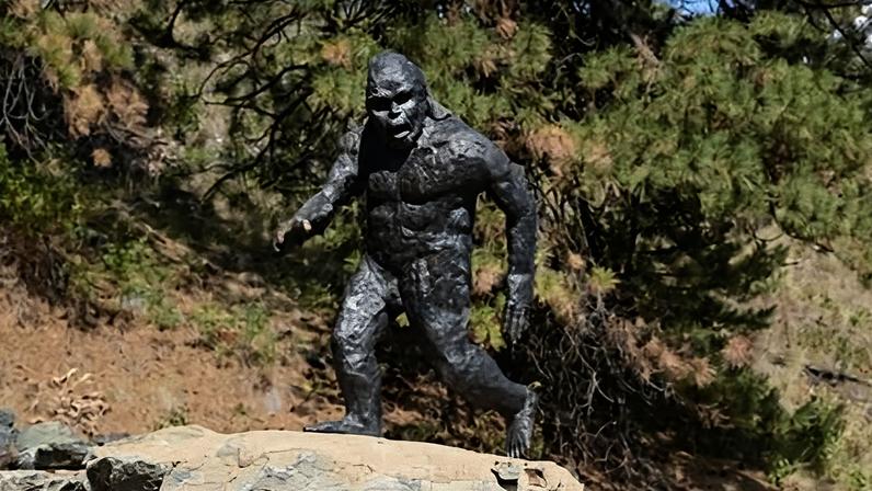 A metal statue of a Sasquatch, or Bigfoot, walking by the side of the Crowsnest Highway, near Osoyoos, British Columbia, Canada.