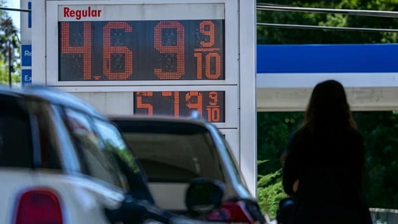 People pump gas at a gas station in Washington DC on 30 May 2026.