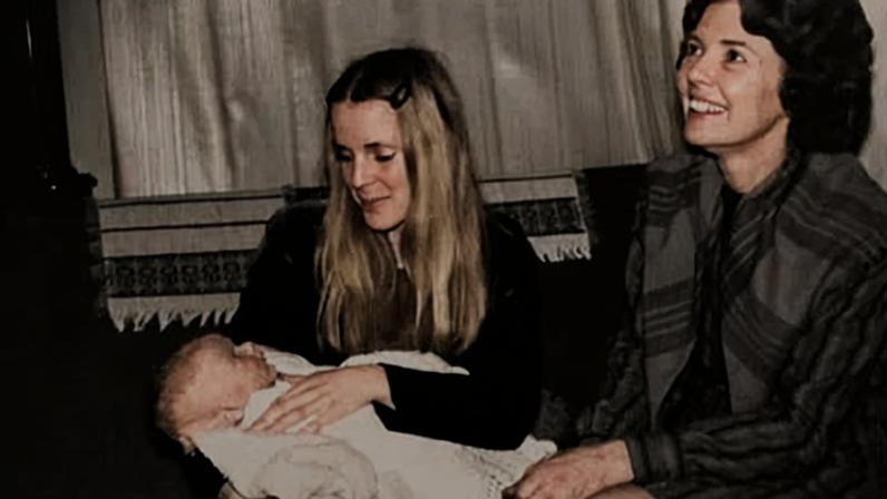 David is cradled by his birth mother, Susan Barras; her mother is next to her.