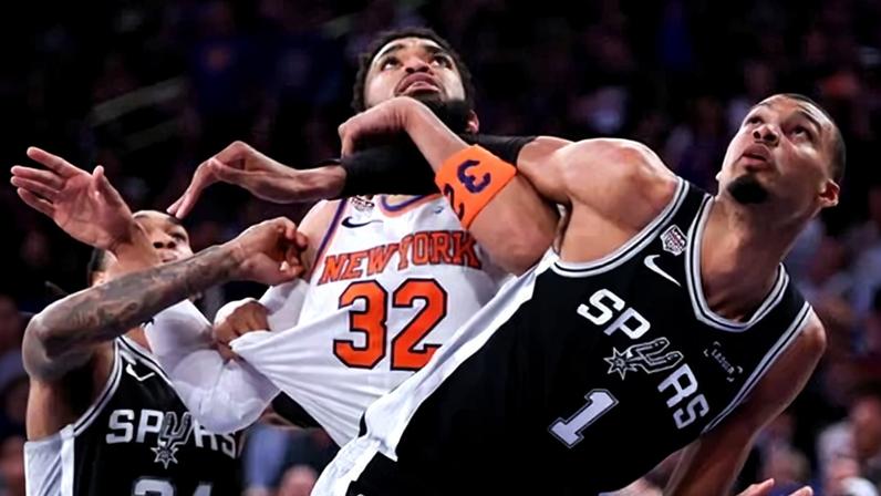 Karl-Anthony Towns and Victor Wembanyama get tangled up on a play during the fourth quarter of Monday night’s game.