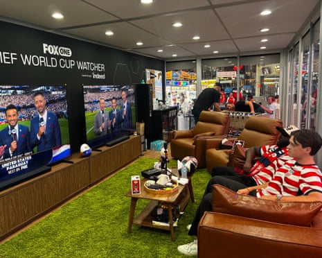 Austin Franklin (right) and Kevin Kotoko watch the World Cup while locked in a cube in Times Square, New York.