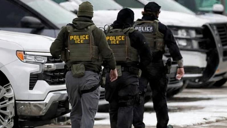ICE agents depart the Bishop Henry Whipple federal building on 4 February in Minneapolis, Minnesota.