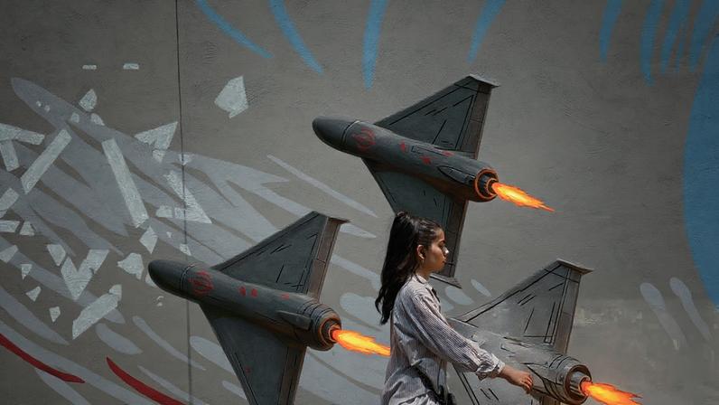 An Iranian girl walks past an anti-Israeli mural on a street in Tehran. The mural depicts three fighter jets in formation firing on and shattering a large Star of David.