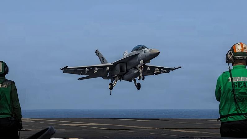A US F/A-18E fighter jet landing on the aircraft carrier USS Abraham Lincoln last week. Iran has attacked a US base after the US struck military sites in Iran.