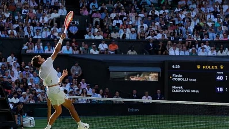 Flavio Cobolli smashes the ball during his quarter-final against Novak Djokovic in last year’s Wimbledon semi-finals.