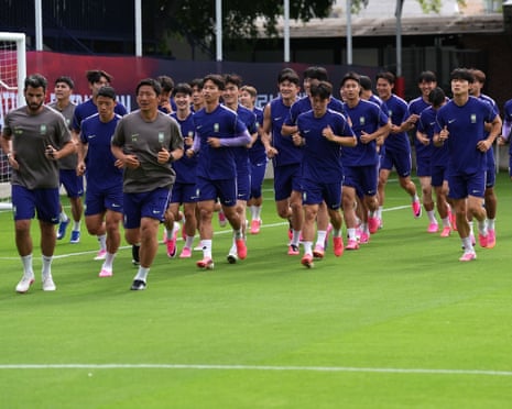 Players of South Korea run during a training session