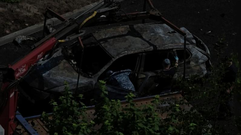 Investigators work at the site of a car bombing that killed the driver in Balashikha, outside Moscow.