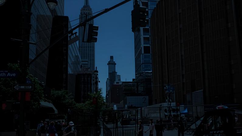 People walk near a security fence outside Madison Square Garden in New York City.