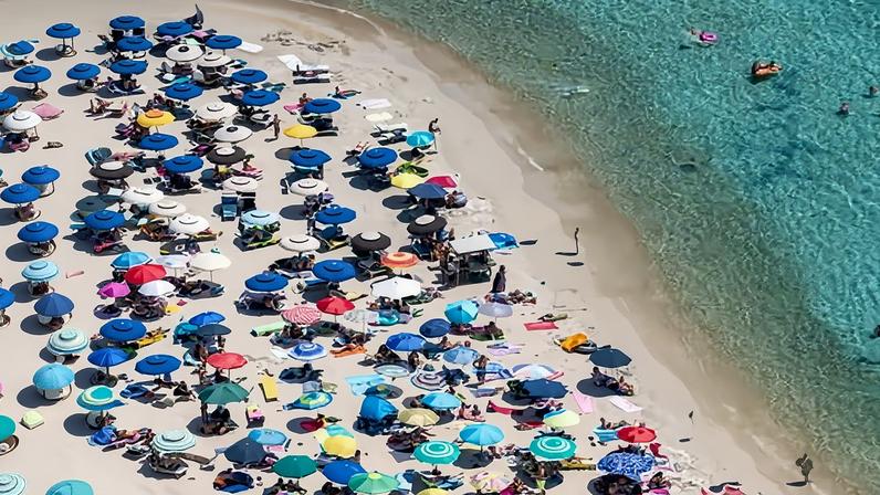 Aerial view of the beach umbrellas at Punta Molentis in July 2019 in Villasimius, Italy.