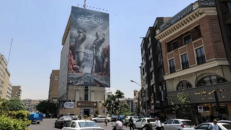 Commuters drive past a large banner depicting the closure of the strait of Hormuz in Tehran, Iran. The US said it attacked Iranian radar sites and intercepted drones.