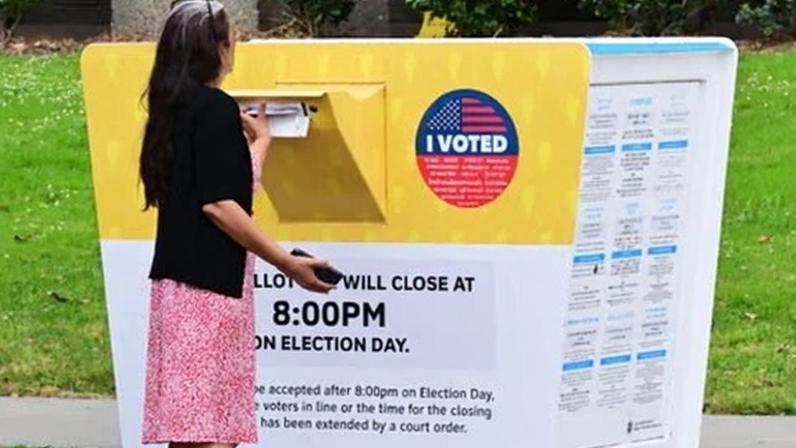A voter places their ballot in a dropbox in Norwalk, California on Monday.