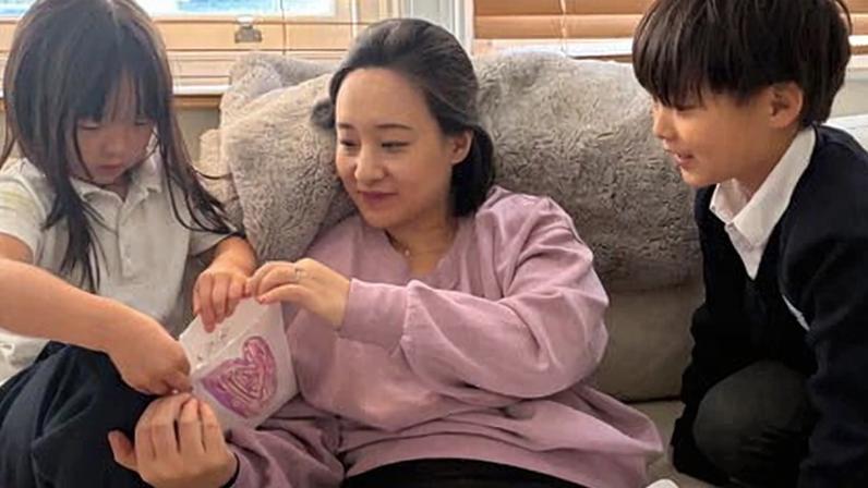 Settling in for the late shift … Catherine Cho with her children.