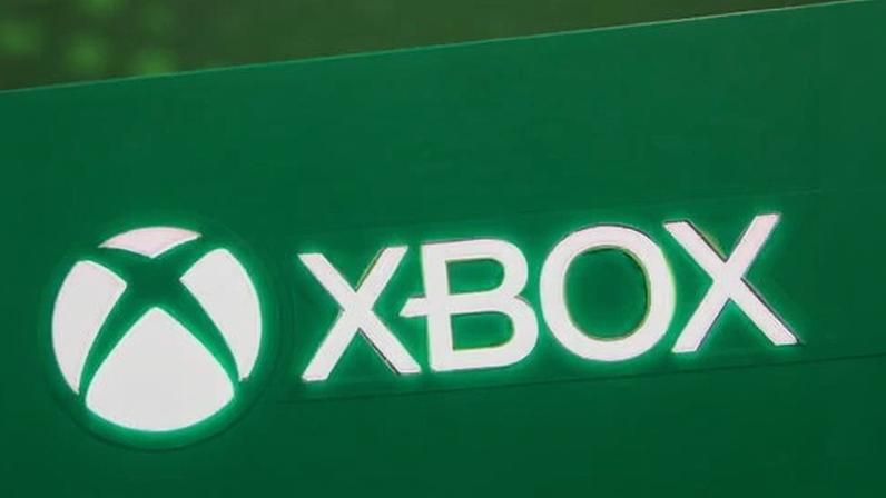 The white Xbox logo and icon are displayed on a green illuminated surface