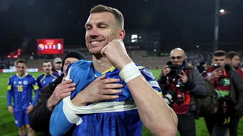 A battered and bruised Edin Dzeko celebrates his country qualifying for the World Cup by beating Italy on penalties.