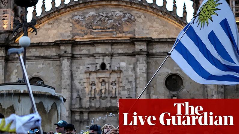 Uruguay fans hold flags outside a cathedral in Guadalajara ahead of Friday's World Cup match against Spain.