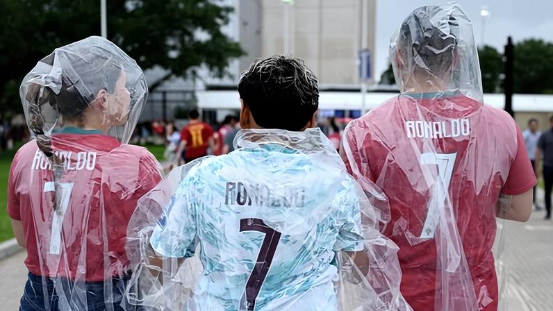 Portugal fans wear ponchos and Cristiano Ronaldo shirts.