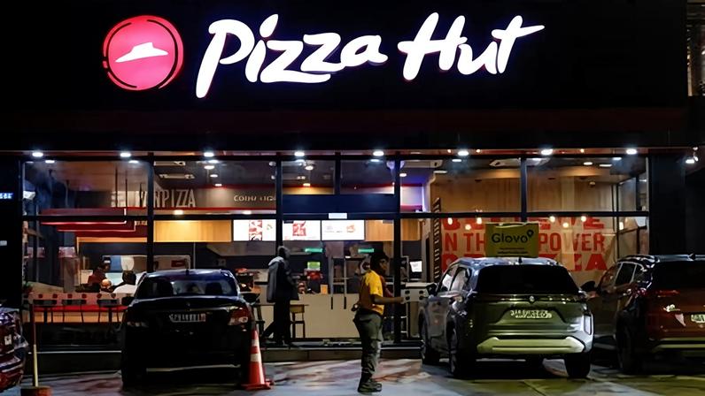 A security guard stands in front of a Pizza Hut in Abidjan, Ivory Coast, on 5 October 2024.
