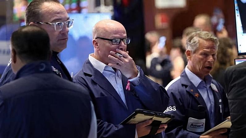 Traders work on the floor at the New York Stock Exchange on 22 June 2026.