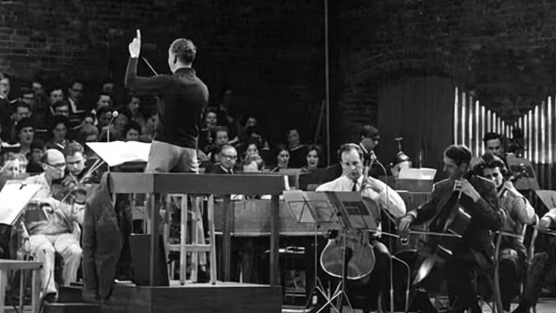Benjamin Britten conducting a rehearsal for the opening of the Snape Maltings Concert Hall in June 1967, with Anita Lasker-Wallfisch the second cellist on the right.