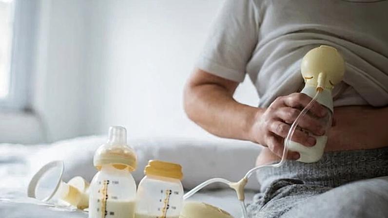Woman Holding Breast Pump Bottle