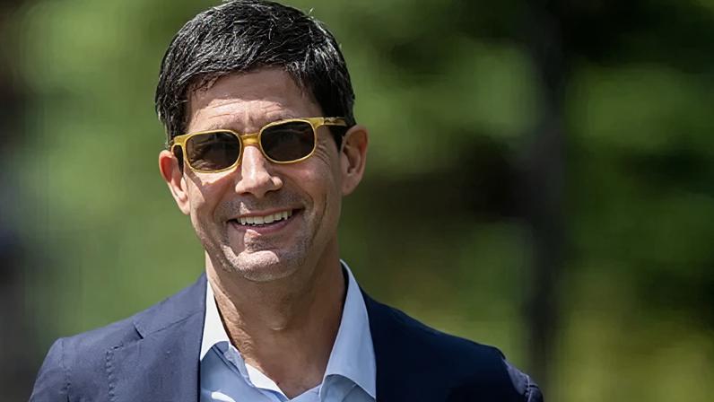 Getty Images Federal Reserve chairman Kevin Warsh is pictured smiling in yellow sunglasses with a navy suit jacket and white shirt.