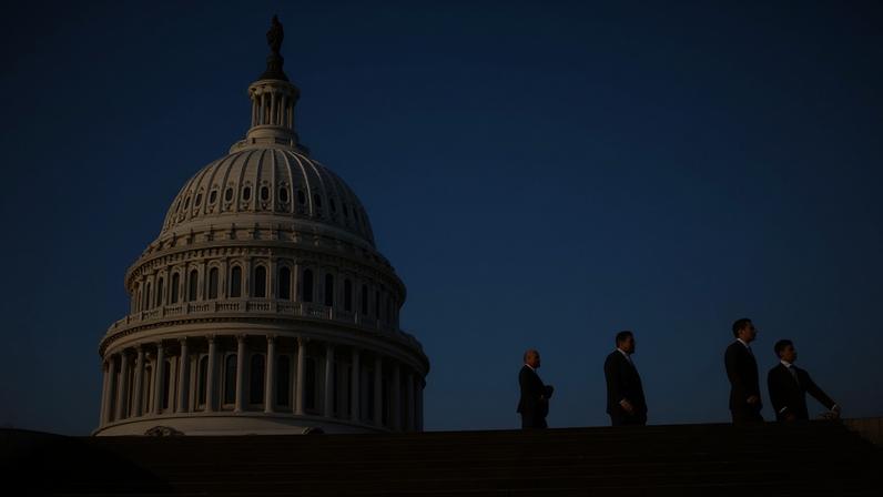People walk past the US Capitol in Washington DC.