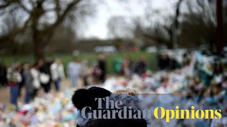 Two people at a memorial for Sarah Everard at the Clapham Common bandstand, London, 21 March 2021.