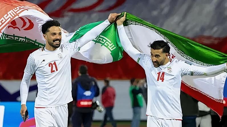 Iran players Omid Norafkan and Saman Ghoddos celebrate after a qualifying match in 2025