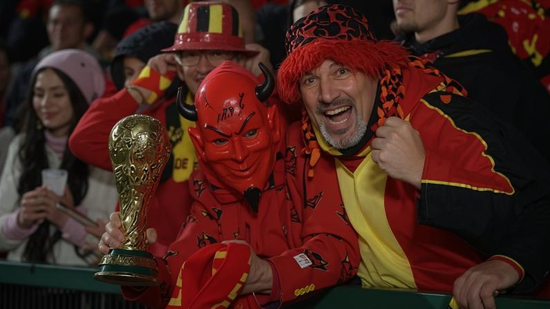 Belgium fans celebrate holding a replica World Cup trophy