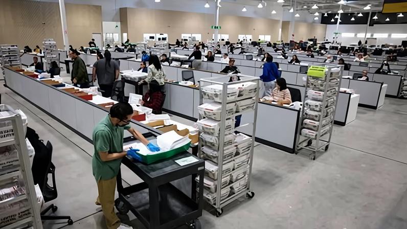 Workers in City of Industry, California, count primary election ballots last week.