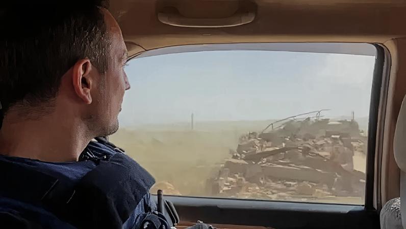 Hugo Bachega looking out of a window in a car