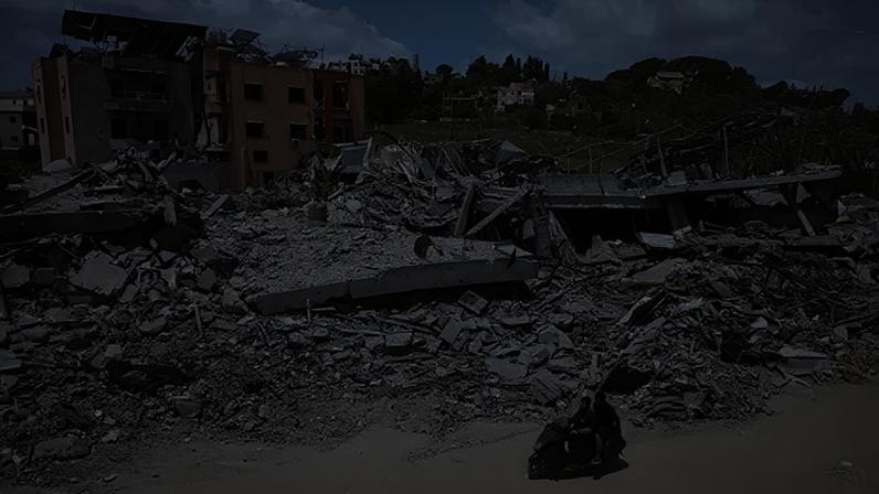 EPA A man riding a motorcycle past destroyed buildings in the village of Mayfadoun, southern Lebanon (23 June 2026)