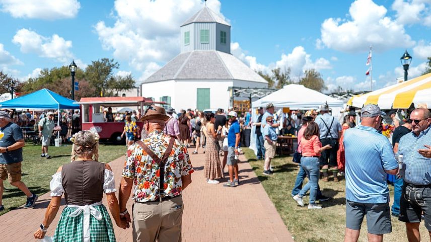 Attendees sit together during the 45th Oktoberfest festival on October 04, 2025 in Fredericksburg, Texas. The festival celebrates traditional German lore and heritage.