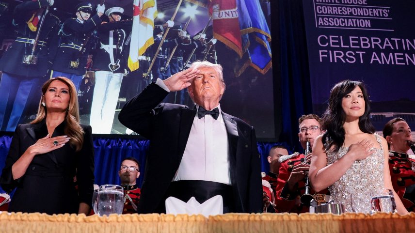 President Donald Trump, with first lady Melania Trump and CBS News senior White House correspondent Weijia Jiang, salutes during the annual White House Correspondents' Association dinner in Washington, D.C., U.S., April 25, 2026.