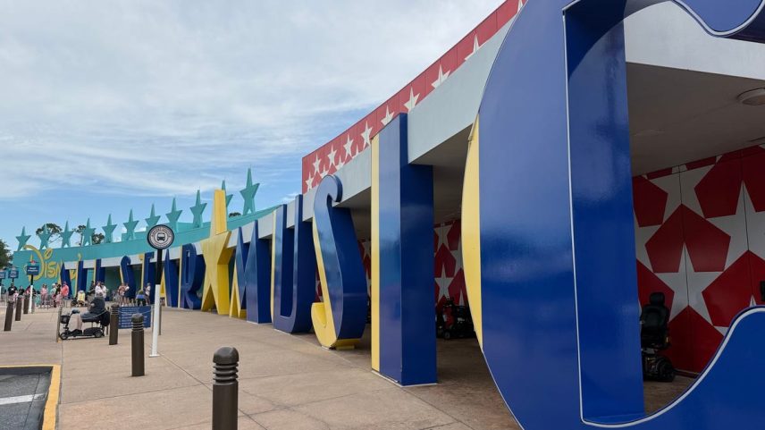 An antique car sits between buildings in the Rock Inn section of Disney's All-Star Music Resort.