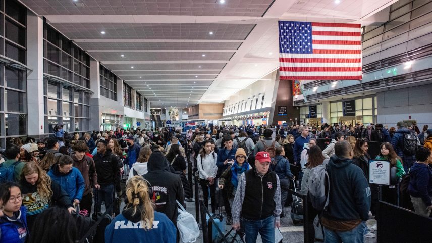 Travelers wait in the security line in Terminal A at Boston Logan International Airport in Boston on Dec. 21, 2023.