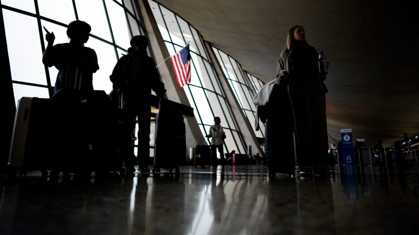 Travelers move through Washington Dulles International Airport on May 22, 2026, in Dulles, Virginia.