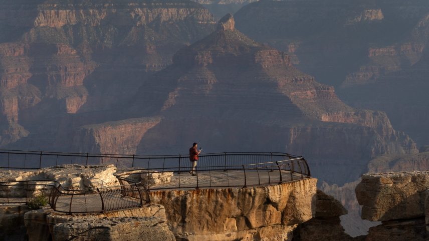Visitors watch the sun rise from the South Rim on July 16, 2025 in Grand Canyon, Arizona.