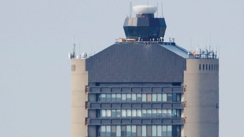 An American Airlines aircraft takes off past the air traffic control tower at Logan International Airport.