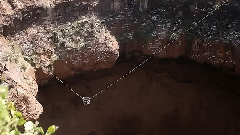 Yemen civil defence Two wires with a cage on them stretch the length of a volcanic crater during a rescue mission to retrieve the body of a free-climber.