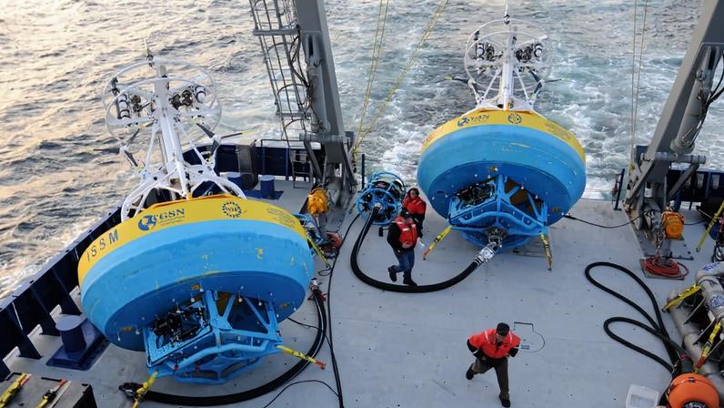 In this 2021 image provided by Woods Hole Oceanographic Institution, workers walk near buoys used to gather data at Pioneer New England shelf off the coast of Martha’s Vineyard, Mass. Image courtesy of Véronique LaCapra/Woods Hole Oceanographic Institution via Associated Press.