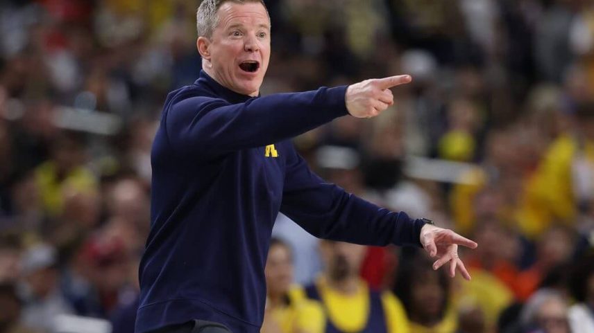 Dusty May points during a game between the Michigan Wolverines and Arizona Wildcats in the Final Four of the 2026 NCAA Men's Basketball Tournament.