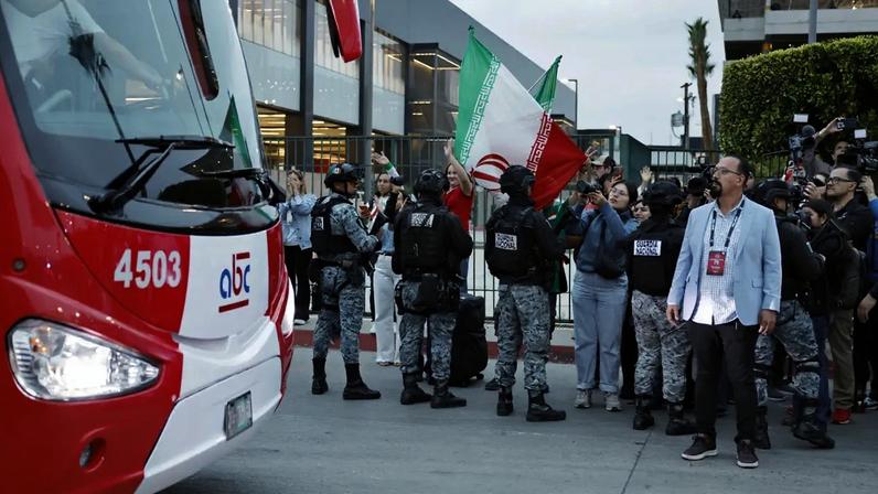 TIJUANA, MEXICO - JUNE 07: Soccer fans wave as the Iranian national soccer team departs on a bus from Tijuana International Airport on June 7, 2026 in Tijuana, Mexico. The team's World Cup participation has been complicated by the Iran war, with the team now training in Tijuana, Mexico instead of Tucson, Arizona amid ongoing U.S. visa processing issues. Iran will play its first two games across the U.S. border in Southern California against New Zealand on June 15 and against Belgium on June 21. (Photo by Mario Tama/Getty Images)