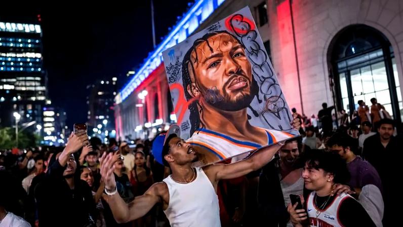 A fan holds an image of Jalen Brunson as New York celebrates the Knicks' NBA championship victory against the Spurs in Game 5.