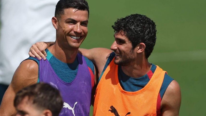 Cristiano Ronaldo and Portugal team-mate Goncalo Guedes laugh in training