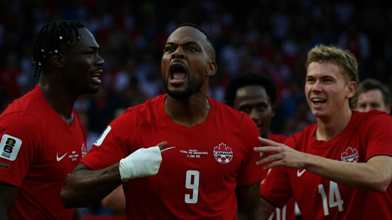 Cyle Larin celebrates with his Canada team-mates after scoring their vital late equalizer