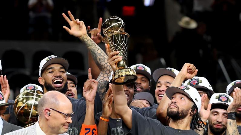 Jalen Brunson lifting the Bill Russell NBA Finals MVP trophy after the Knicks won their first league title in 53 years.