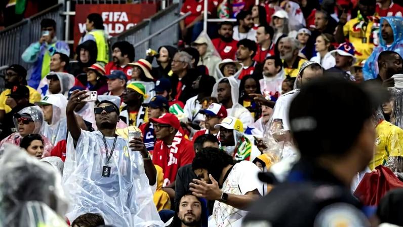Fans wear ponchos in the rain at BMO Field during Ghana's match against Panama