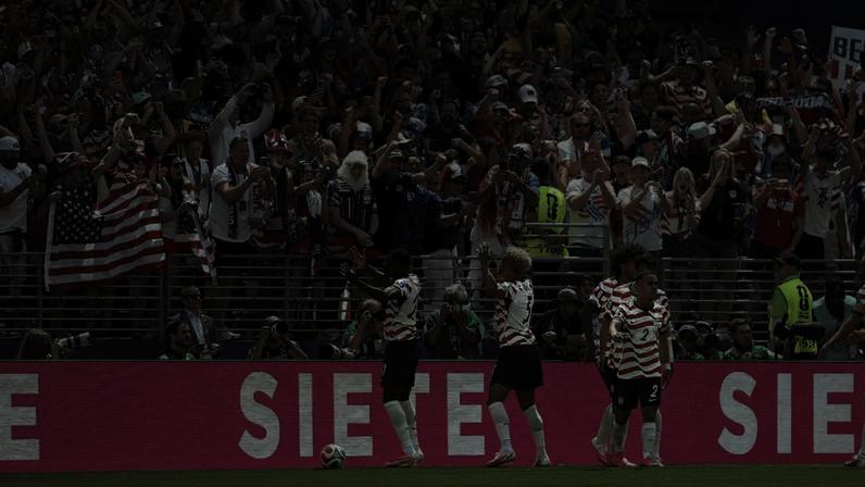 United States players celebrate the team's first of two goals against Australia at Seattle Stadium.